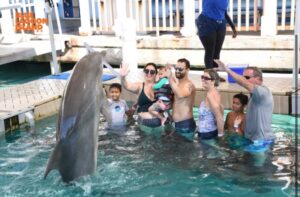 Family with a Dolphin Jumping in front of them